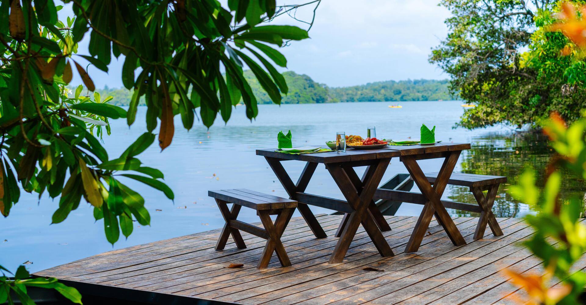 Lakeside dining table set with food overlooking Rathgama Lake at Serendipity Lake